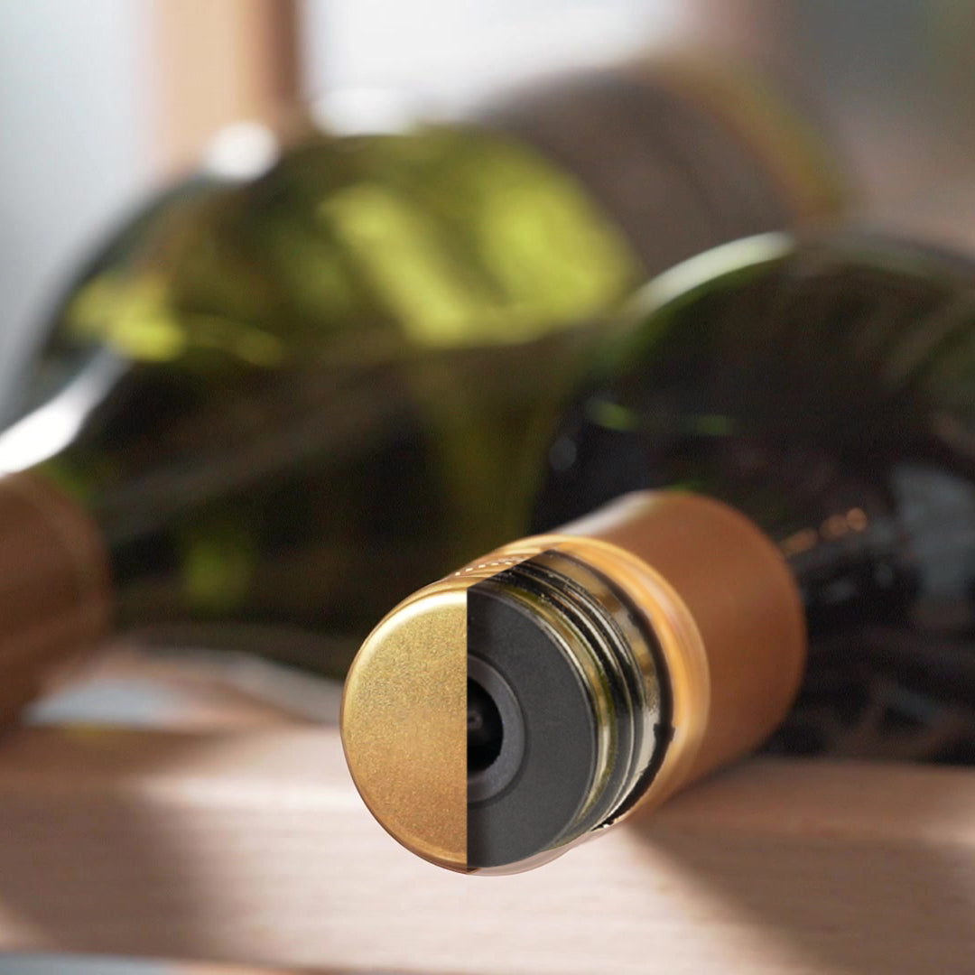 Close-up of a wine bottle with a screw cap, semi cut to reveal a Nanostopper underneath, horizontally in a wine rack with blurred bottles in the background